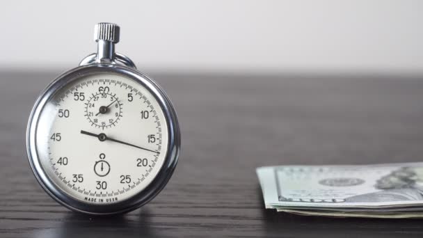 Dollars and stopwatch. Business concept of lost time and failed investments - Footage, Video