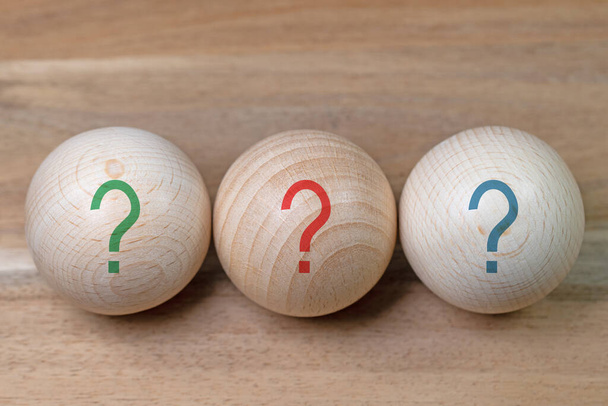 Three wooden balls with printed question marks - Photo, Image