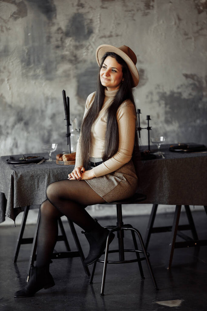 young woman in a hat posing in studio  - Zdjęcie, obraz
