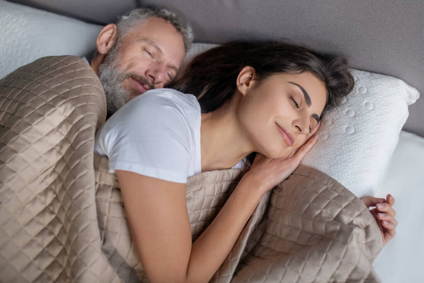 Man and woman sleeping in the bed together - Φωτογραφία, εικόνα