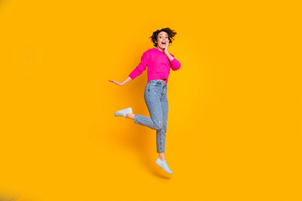 Full length photo of funky lady jump high wear pink pullover isolated yellow color background - Φωτογραφία, εικόνα
