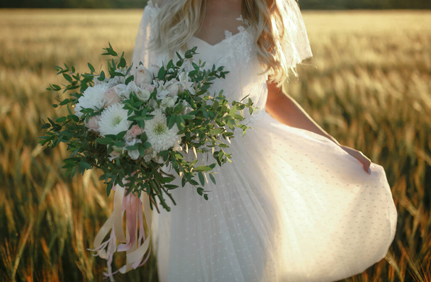 Wedding bouquet in the hands of the bride. - Φωτογραφία, εικόνα