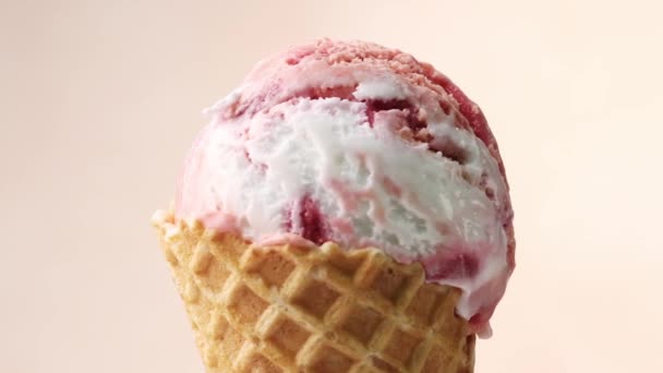close up of rotating vanilla and strawberry ice cream in waffle scoop - Footage, Video