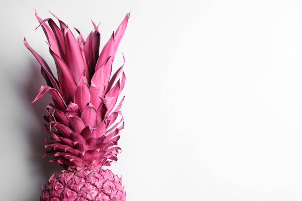 Painted pink pineapple on white background, top view. Creative concept - Fotó, kép