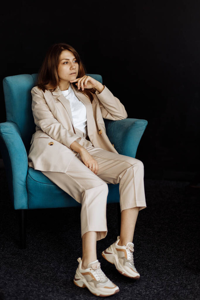 portrait of  beautiful young woman   on chair  in studio  - Valokuva, kuva