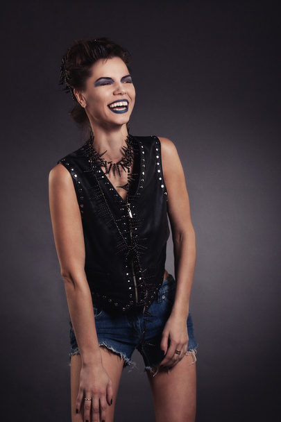 Sexy woman rocker image with creative makeup blue laughing - Photo, image