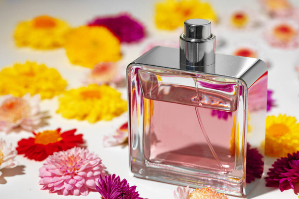 Perfume bottle for women in flower buds - Фото, изображение