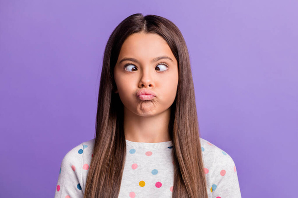 Photo portrait of silly girl grimacing looking at nose pouting isolated on vivid violet colored background - Фото, зображення