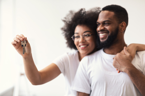 Happy African Couple Holding New House Key Hugging Standing Indoor - Photo, image