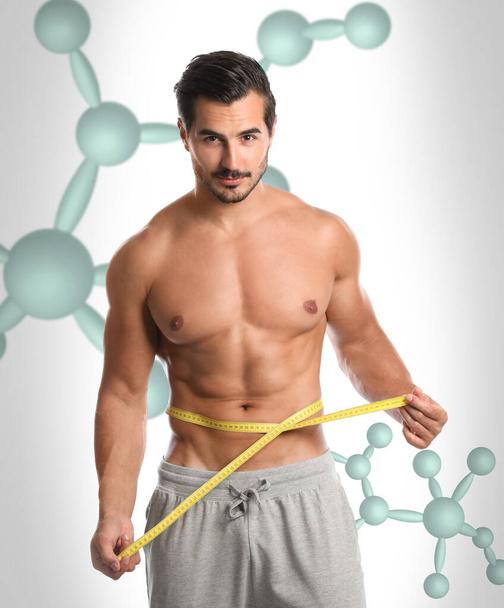 Metabolism concept. Man with slim body on light background   - Φωτογραφία, εικόνα