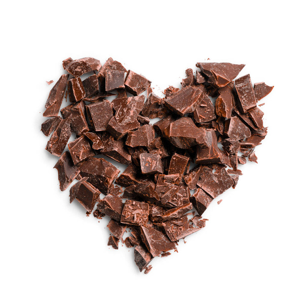 Heart made with dark chocolate crumbles on white background, top view - Foto, imagen