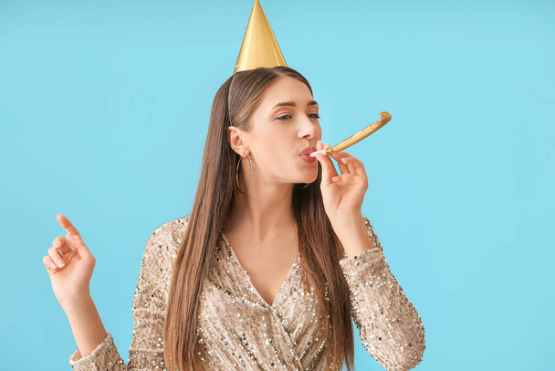 Young woman celebrating birthday on color background - Фото, изображение