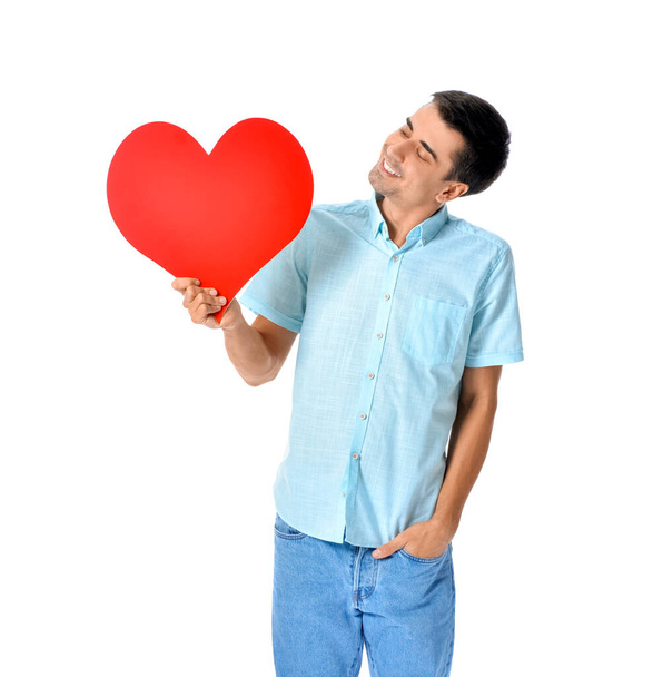 Handsome man with big red heart on white background - Foto, Imagen