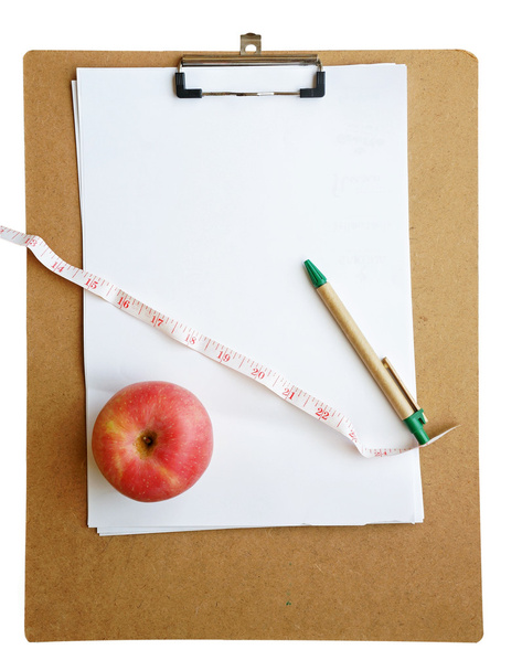 czerwone jabłko i centymetrem w Schowku z piórem (koncepcja zdrowia) - Zdjęcie, obraz