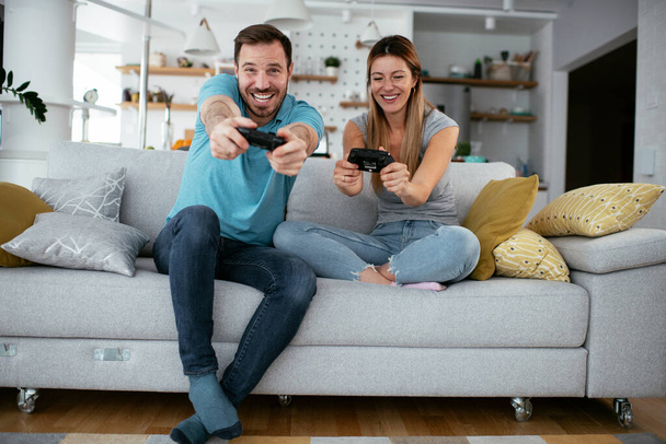 couple playing video games at home  - Photo, Image