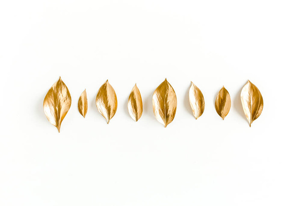 Pattern, texture with gold leaves isolated on white background. flat lay, top view - Foto, Imagen