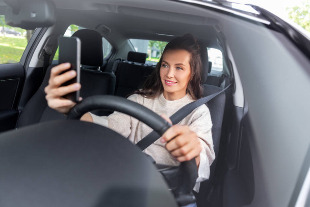 woman or driver driving car and taking selfie - Foto, immagini