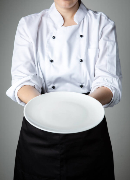 chef uniform with white empty plate welcome present dish restaurant promotion - Photo, Image