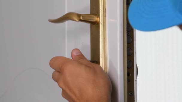 Cerrajero instalando cerradura de puerta con destornillador. - Metraje, vídeo