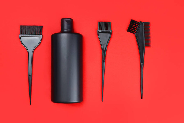 Set for hair coloring on a red background - Photo, Image