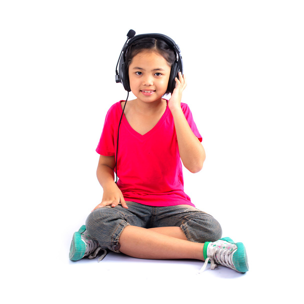 Little girl is enjoying music - Foto, afbeelding
