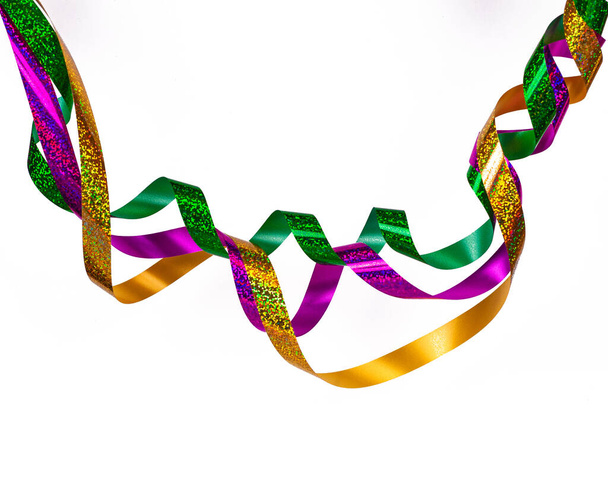 Foil serpentine hanging in a wave.Yellow, red and green ribbons.Copy space. - Photo, Image