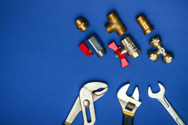 A set of tools for plumbing isolated on a blue background - Photo, Image