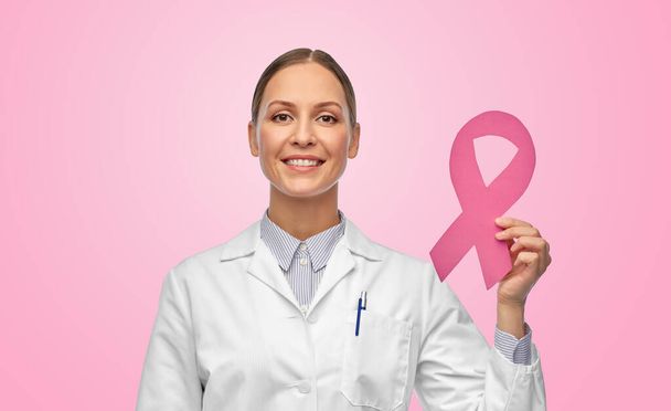 female doctor with breast cancer awareness ribbon - Foto, Imagen