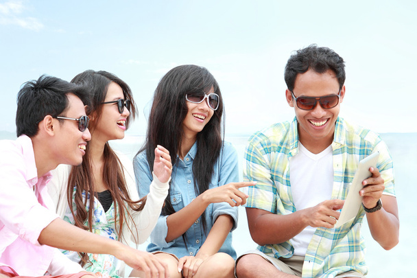 Group Friends Enjoying Beach Holiday together with tablet pc - Photo, image