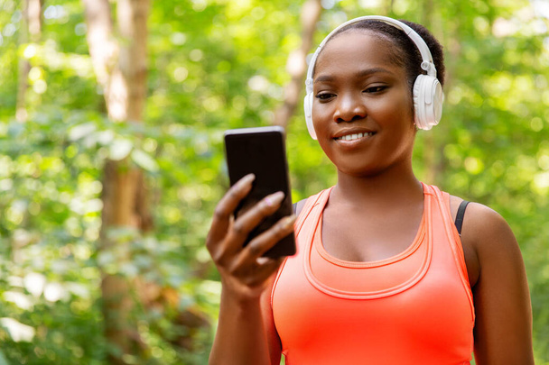 african american woman with headphones and phone - Φωτογραφία, εικόνα