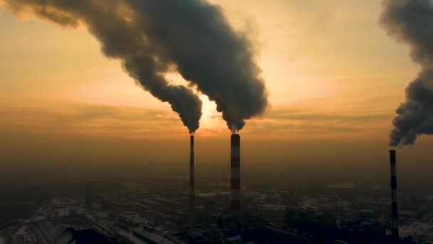 Power Plant emissions seen above the city  during sunrise. Environmental pollution. Factory pipe polluting air.Panorama sunset. Smoking pipes Aerial view, - Footage, Video