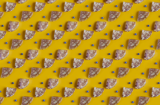 Pancakes pattern with blueberries on yellow background. Top view, close up - Foto, Bild