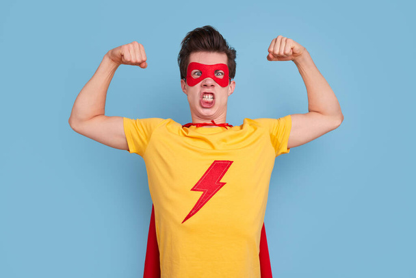 Crazy male superhero showing biceps - Photo, image