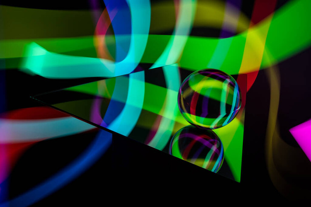 Γυάλινη κρυστάλλινη σφαίρα με πολύχρωμο μοτίβο rgb φως ζωγραφική fractals σε μαύρο φόντο - Φωτογραφία, εικόνα