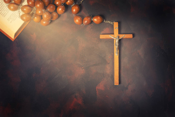 Big wooden Rosary beads and crucifix cross with jesus,red candle and bible book,spiritual atmosphere ,religion concept. - Φωτογραφία, εικόνα