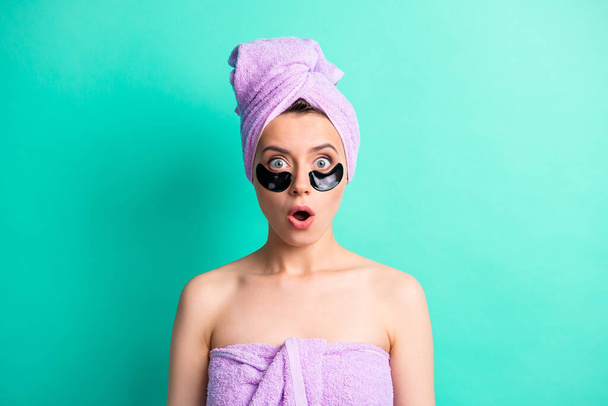 Photo of pretty shocked girl patches under eyes open mouth wear purple towel turban isolated turquoise color background - Fotografie, Obrázek