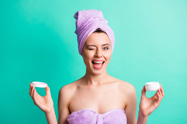 Photo of flirty girl hold open cream container blink close eye wear violet towel turban isolated teal color background - 写真・画像