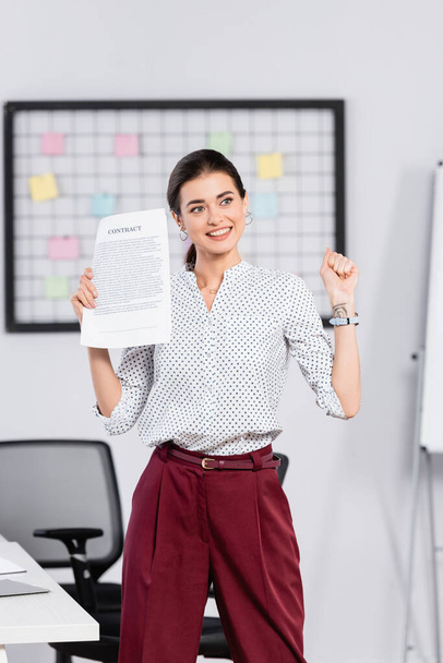 happy businesswoman holding contract in office - Photo, Image