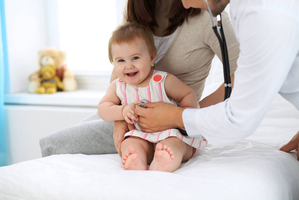 Doctor and patient. Happy cute baby at health exam. Medicine and health care concept - Photo, image