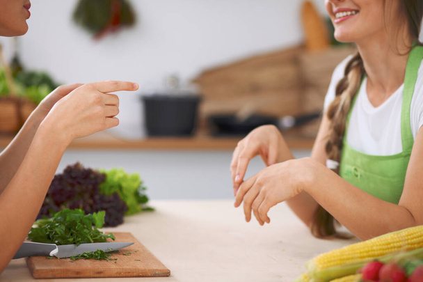 Close-up of human hands cooking vegetables salad in kitchen. Healthy meal and vegetarian concept - Foto, immagini