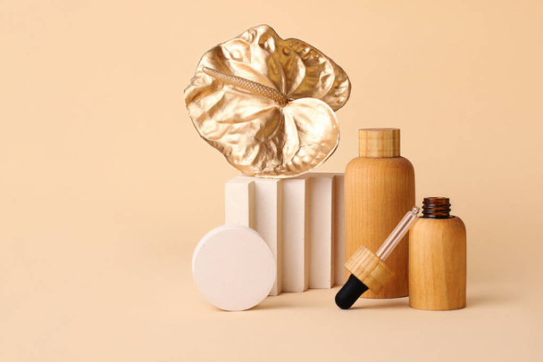 Wooden cosmetics containers with geometrical podium and golden flamingo flower near it.Concept of the zero waste products.Beatiful pastel colors,good as mockup. - Photo, Image