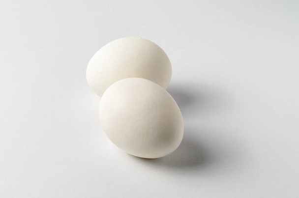 Still life with two chicken eggs on a white background  - Fotoğraf, Görsel