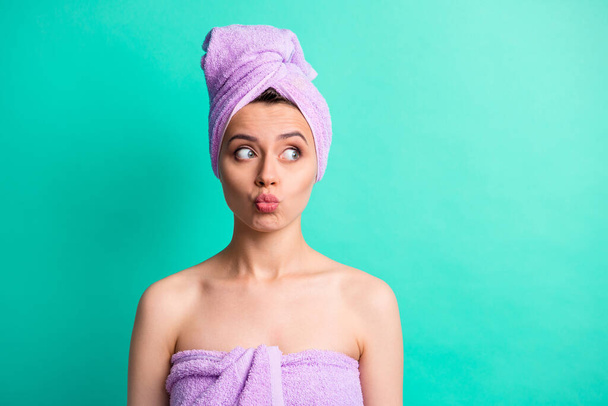 Photo portrait funny woman turban on head doing spa procedures pouted lips looking at copyspace isolated vibrant teal color background - Foto, imagen