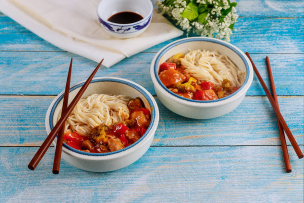Japanese noodles with stir fry vegetable in bowl with chopsticks. Chinese food. - Photo, Image