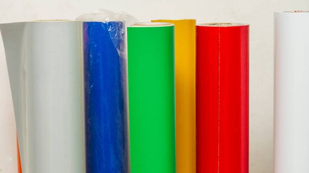 colored vinyl car wrapping or plotter cutting sticker foil film rolls. Film in rolls for advertising - Photo, Image
