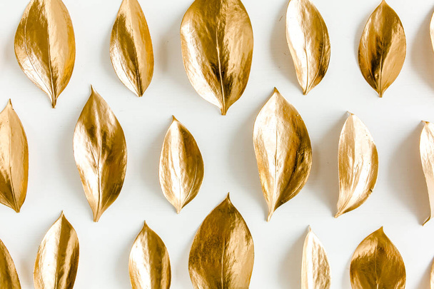 Pattern, texture with gold leaves isolated on white background. flat lay, top view - Foto, Imagem