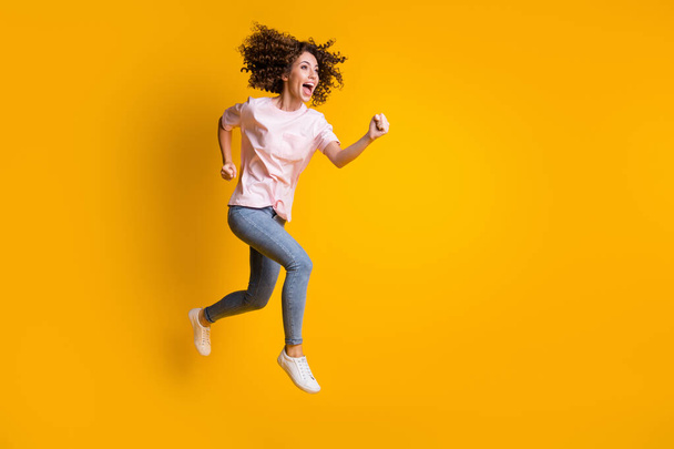Photo portrait full body view of screaming woman jumping up running isolated on vivid yellow colored background - Фото, изображение