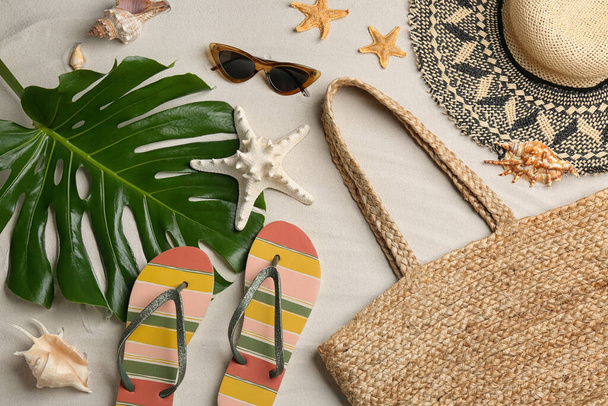 Different beach accessories on sand, flat lay - Foto, imagen