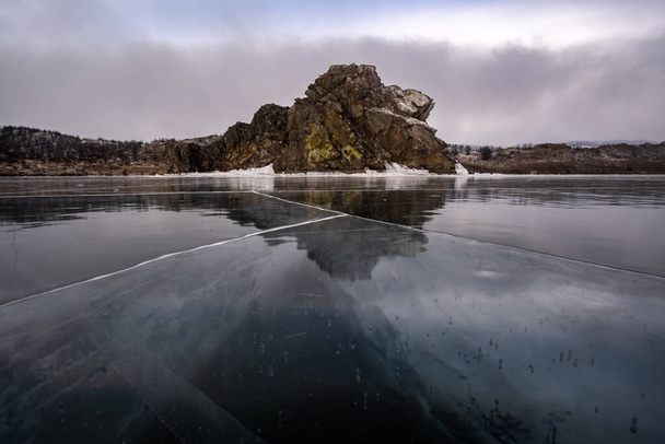 Winter landscape on Lake Baikal with clear ice in the foreground - Foto, Imagen