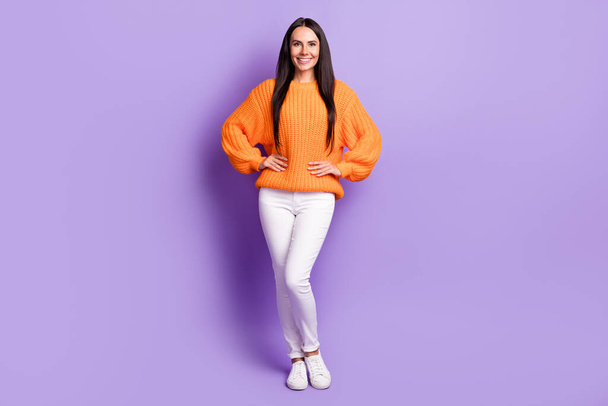 Full size photo of nice optimistic girl wear red sweater trousers sneakers isolated on lilac color background - Foto, Imagen